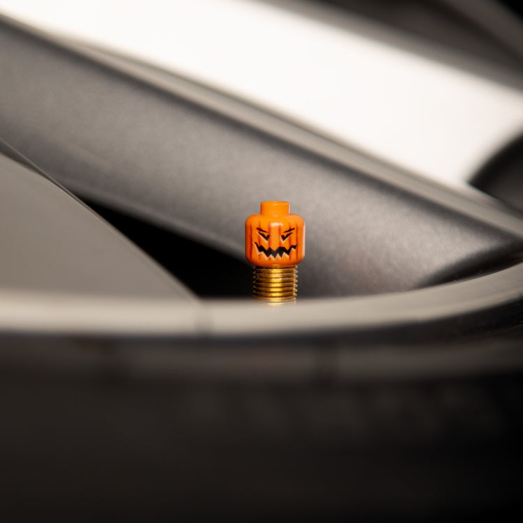 Close-up of the Halloween pumpkin LEGO valve cap showing the jack-o’-lantern face