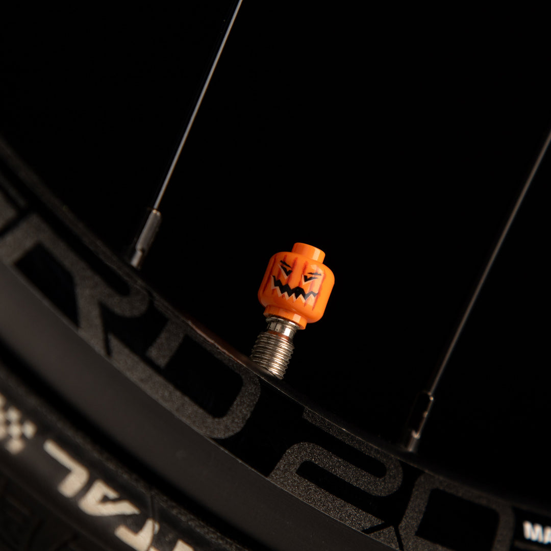 Halloween pumpkin LEGO valve cap fitted to a bicycle valve